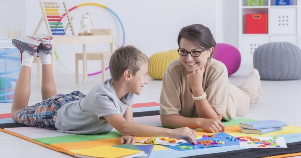 ABA therapist working with child at home